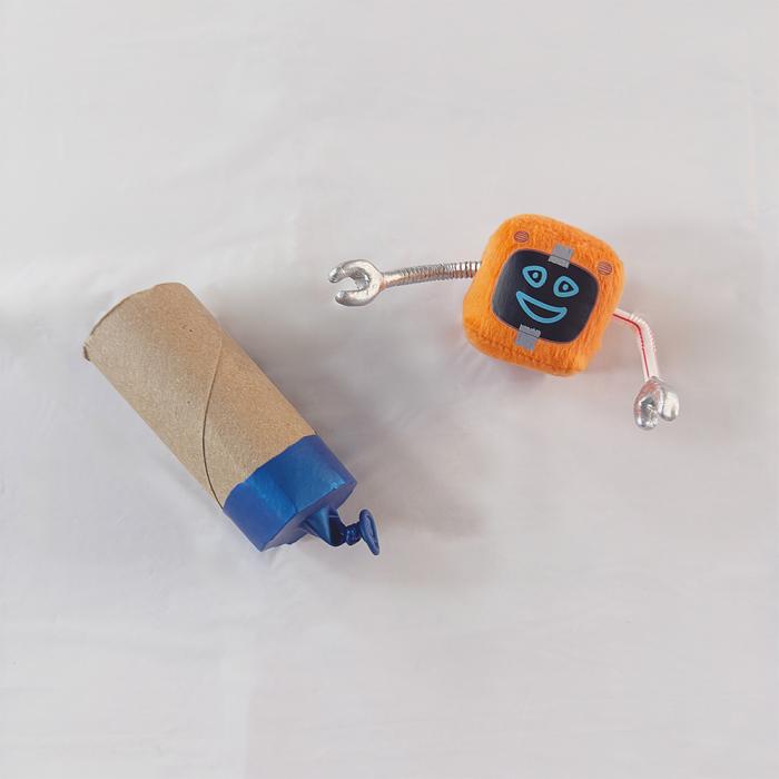 The bottom half of a knotted blue balloon stretched over one end of a short cardboard tube