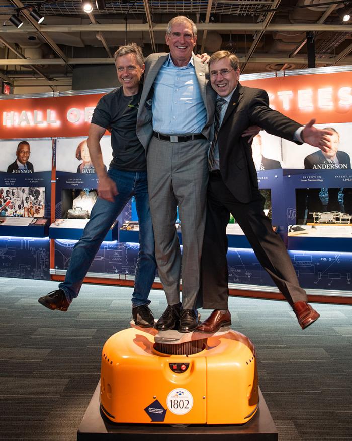 Peter Wurman joins Raffaello D’Andrea and Mick Mountz standing on top of a Kiva Systems robot