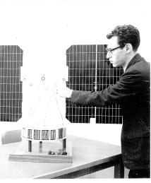 Kaplan with the satellite he worked on at NASA.