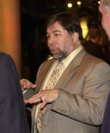 Steve Wozniak talking in a group of men