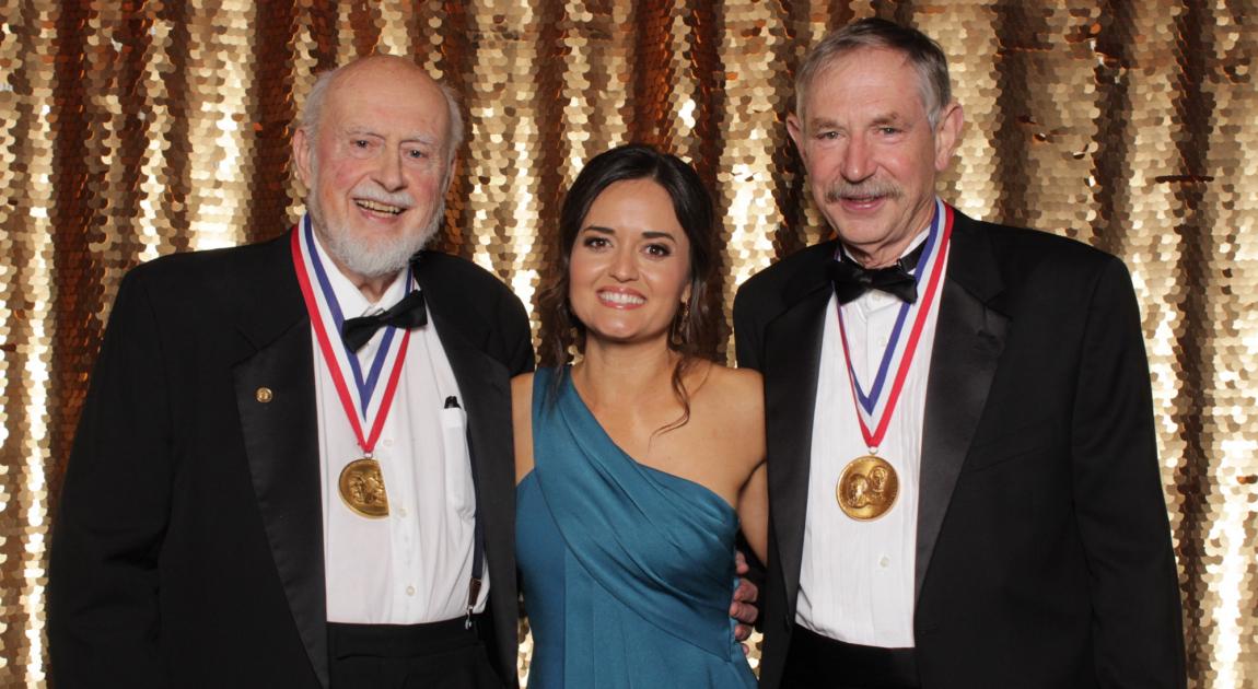 Art Fry, Danica McKellar, and Rox Anderson pose for a group photo in front of a gold curtain after the Induction Ceremony