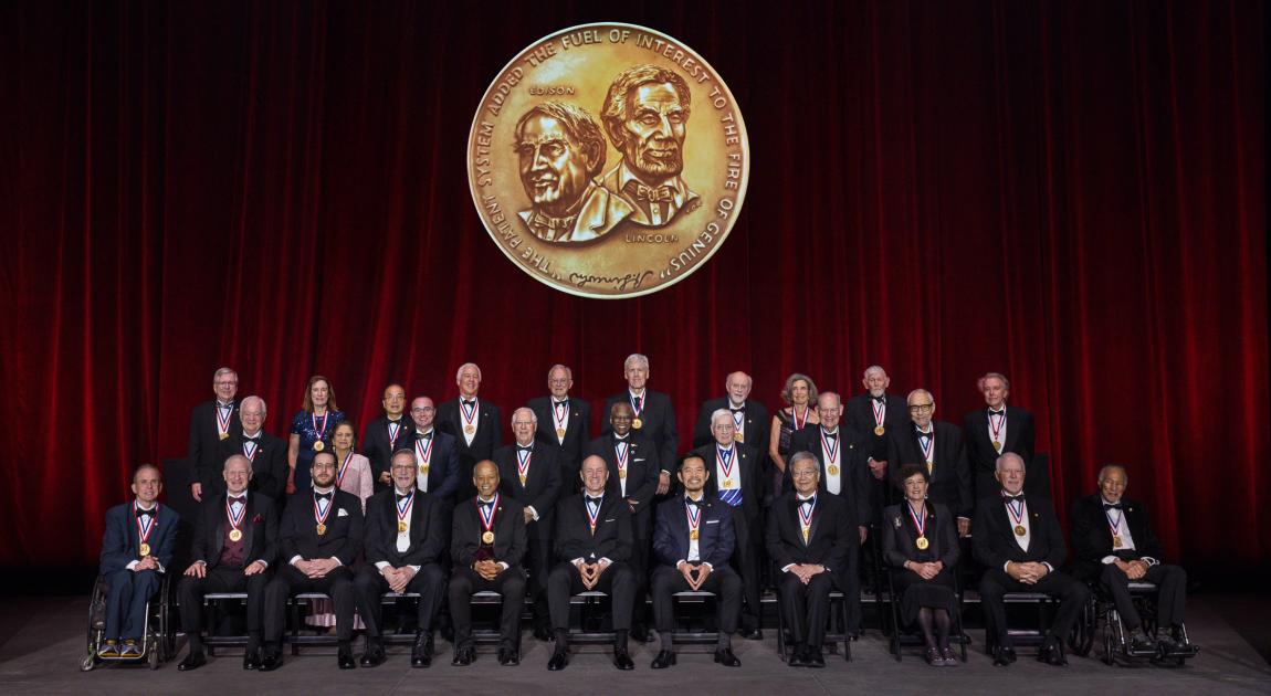 A group of National Inventors Hall of Fame Inductees sit together on the stage during the Induction Ceremony