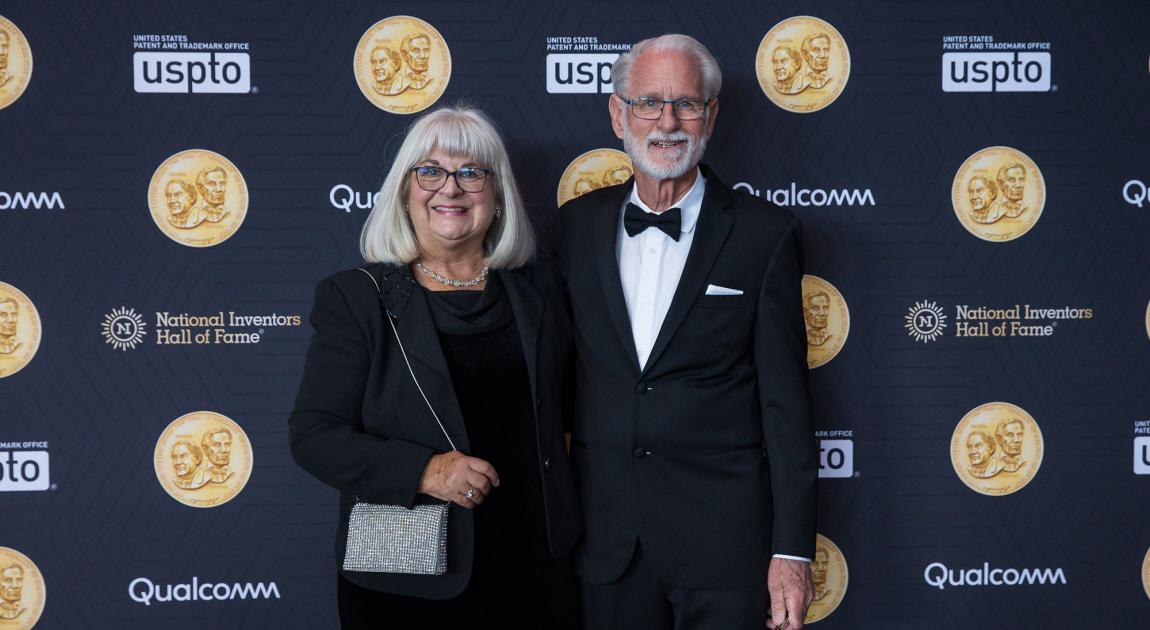 Two attendees of the Hall of Fame Induction Ceremony pause for a photograph before proceeding into the main hall