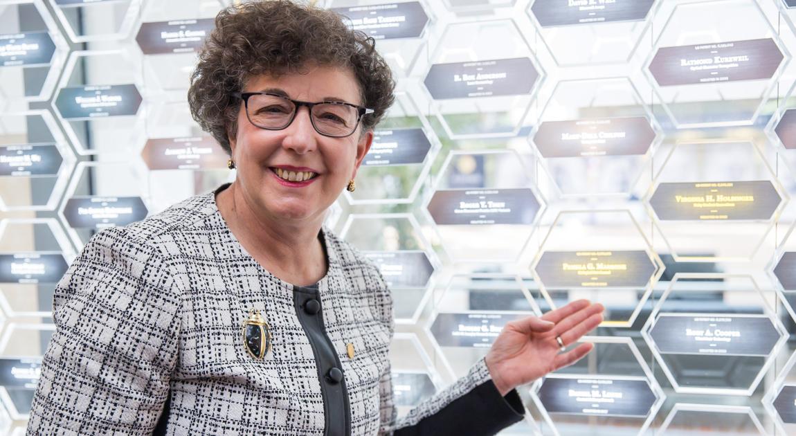 Pamela Marrone smiles and points to her name plaque in the Gallery of Icons