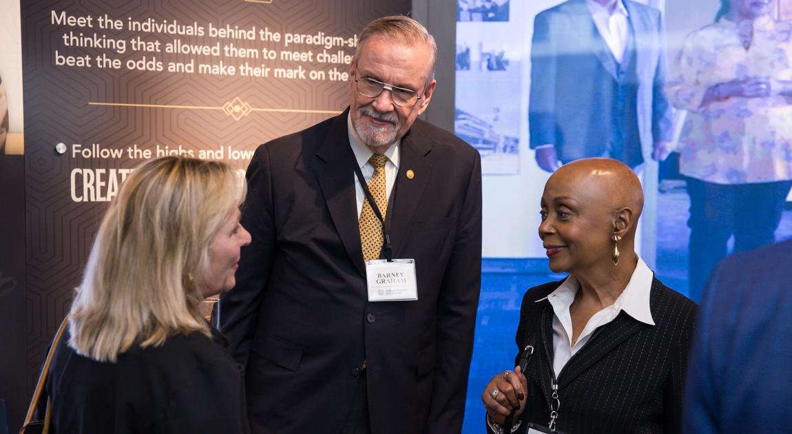 Barney Graham speaks with other Illumination Ceremony attendees at the National Inventors Hall of Fame Museum