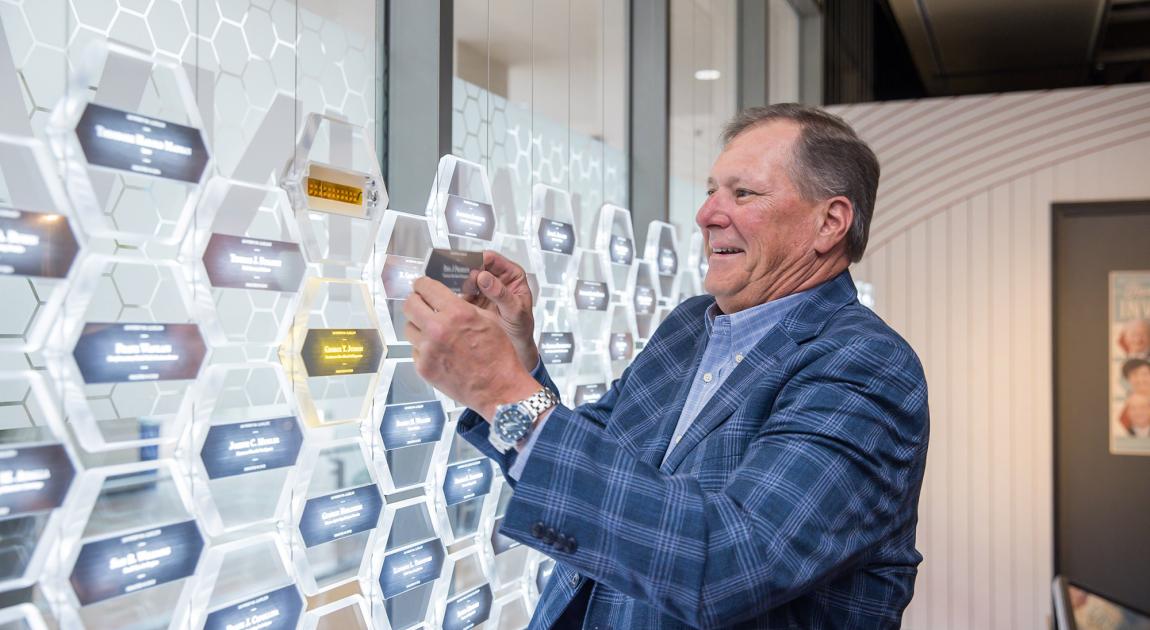 A representative places the name of a historical Inductee into the Gallery of Icons exhibit