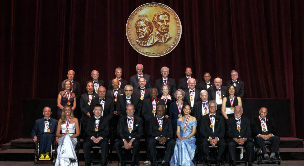A group of National Inventors Hall of Fame Inductees sit together on the stage during the Induction Ceremony