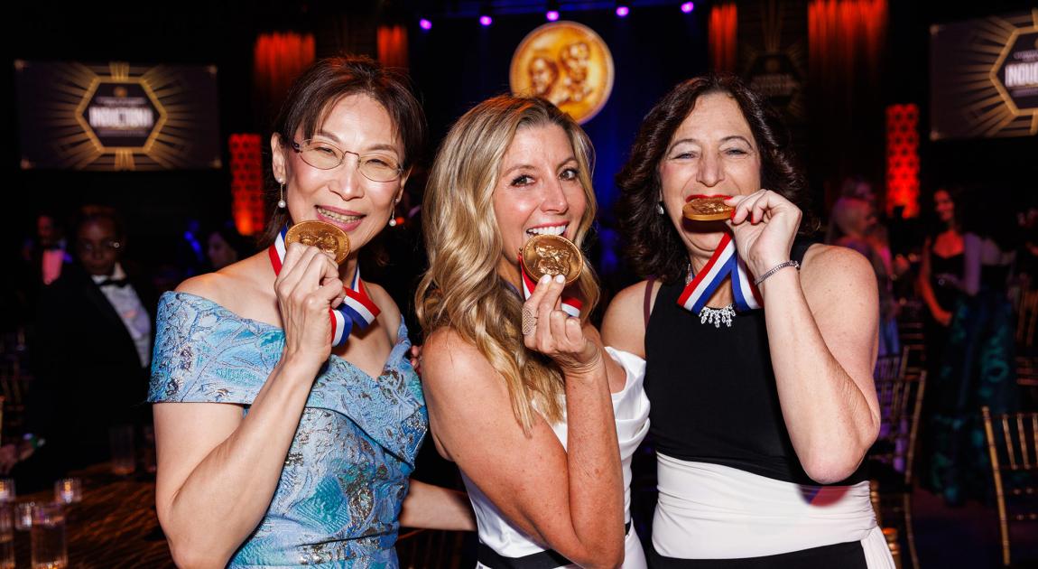 Inductees Teresa Meng, Sara Blakely and Andrea Goldsmith grin and hold up their Inductee medals