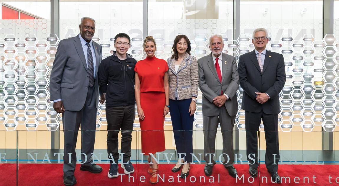 The 2026 National Inventors Hall of Fame Inductee Class in front of the Gallery of Icons museum exhibit