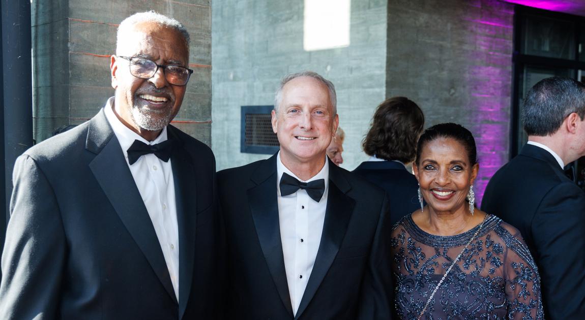 Inductee Gebisa Ejeta smiles with other Induction Ceremony attendees